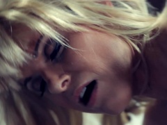 Woman in a blonde wig and black boots enjoys sex on a spaceship