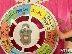 Two sluts in bikinis spin the big wheel