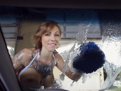 Big breasted lady is washing the car with her large tits