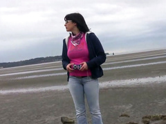 Short haired brunette Shelly provides a man with a blowjob on the beach