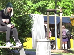 Naughty girl shows us her huge tits in public place