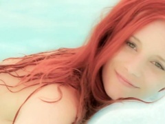 Underwater posing by busty Ariel