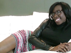 A black chick with a sexy ass and large tits is on the bed, naked